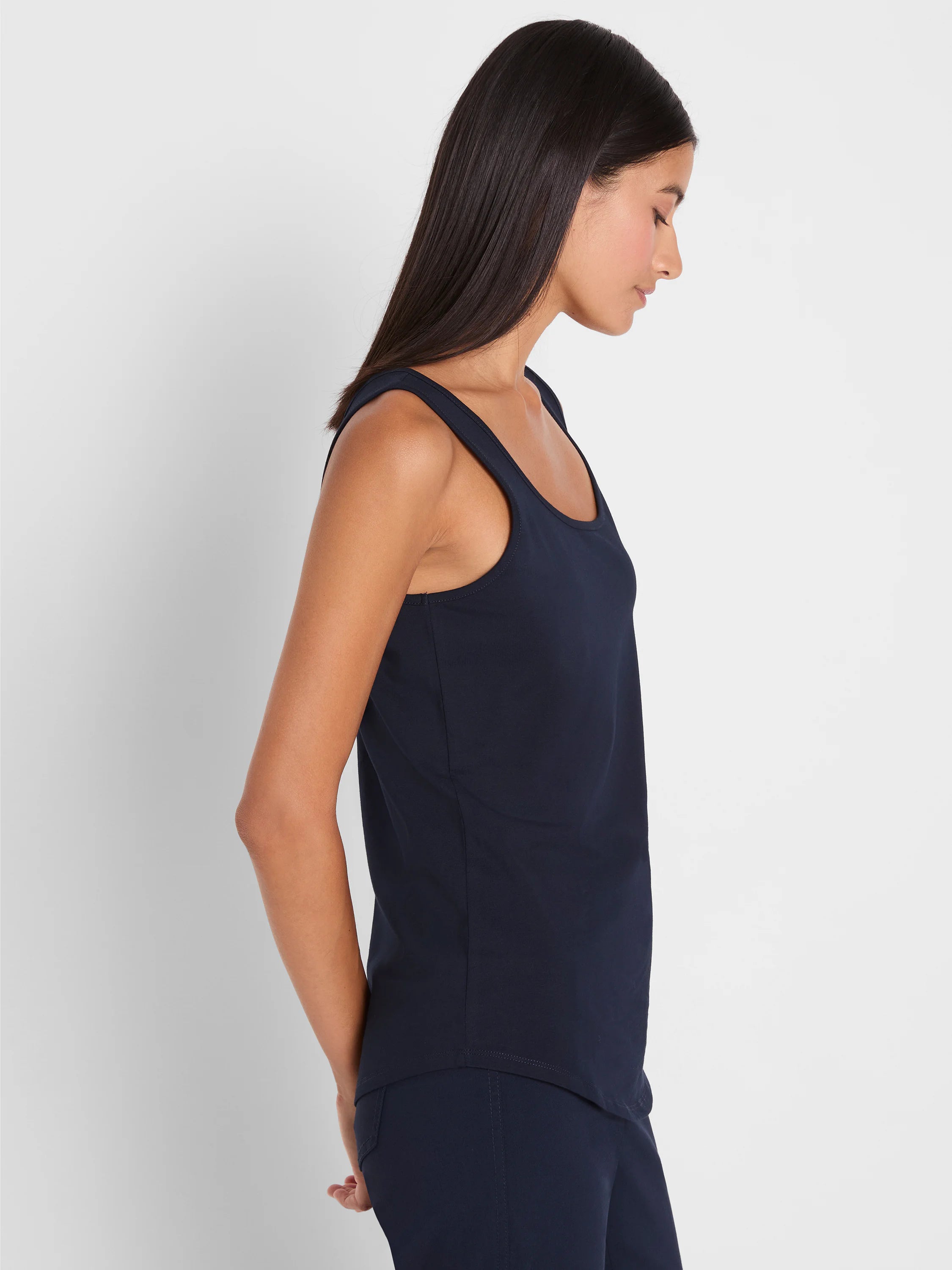 Navy tank top on a model, featuring a scoop neck, wide straps, and a relaxed fit.