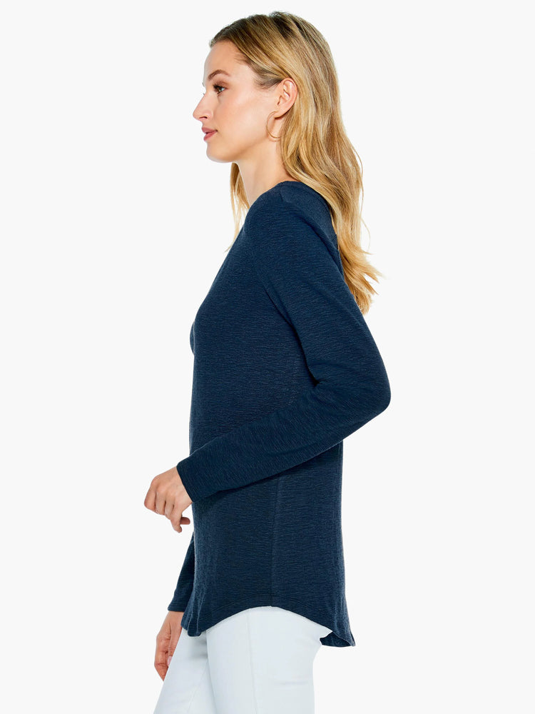 Dark navy blue, long-sleeve top with a slightly curved hem. Textured fabric.