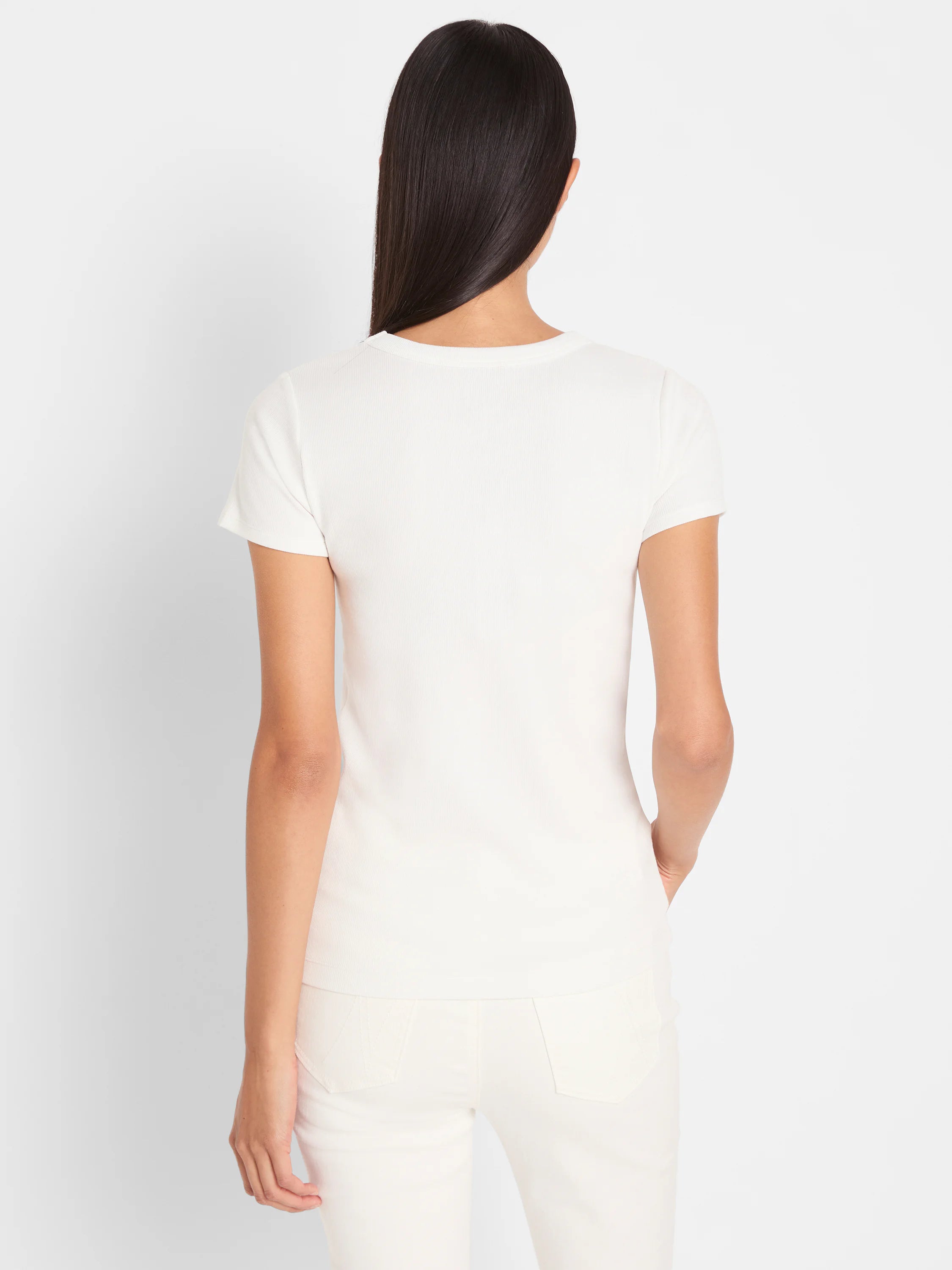White ribbed knit short sleeve crew neck tee on a model, shown from the back.