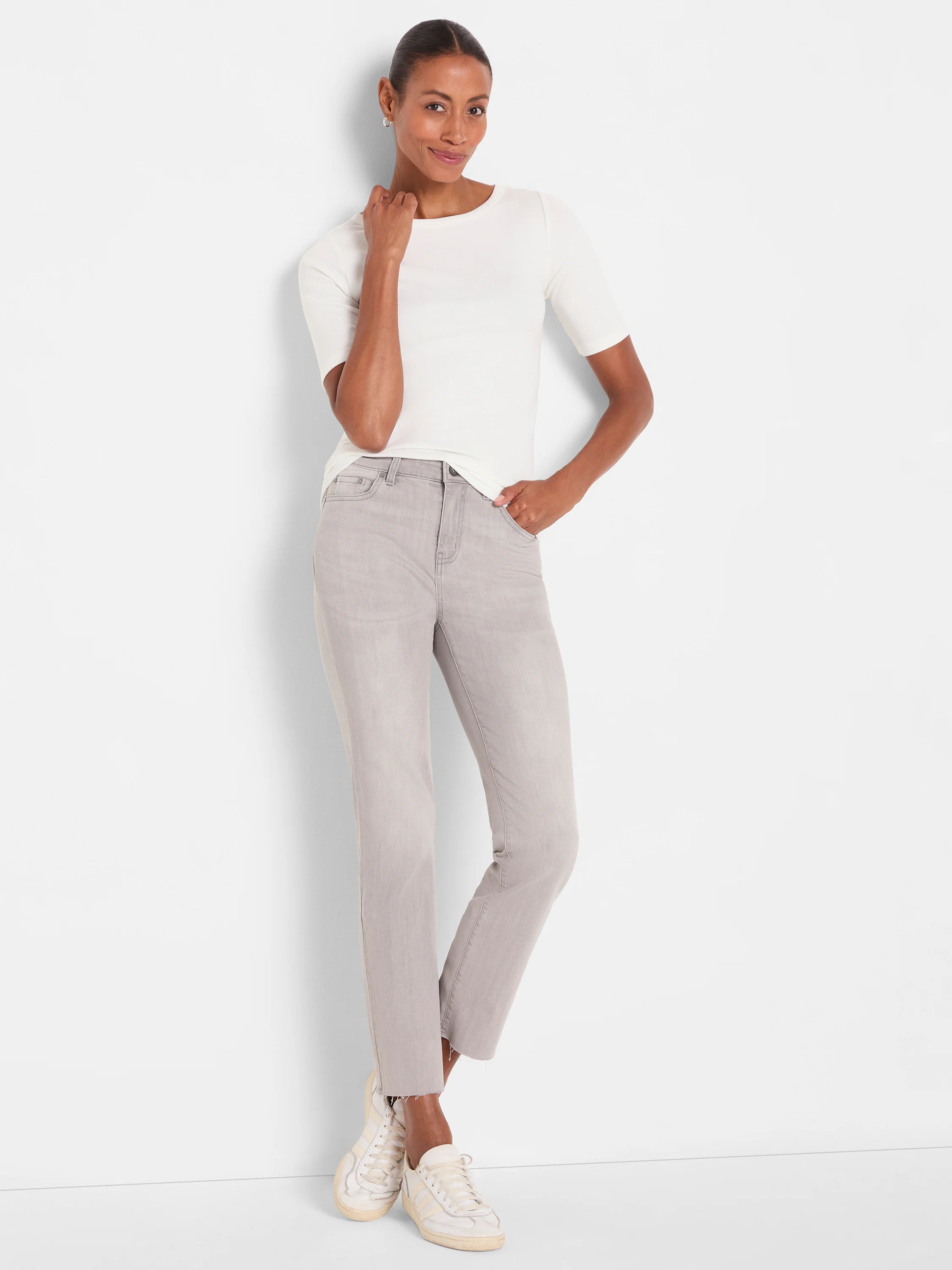 White ribbed tee with elbow sleeves and a boatneck, worn by a model, showing its form-fitting style.