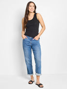 Black ribbed knit scoop neck tank top with wide straps, shown worn by a model.