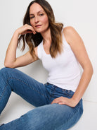 White, ribbed knit, scoop neck tank. Fitted on a model.