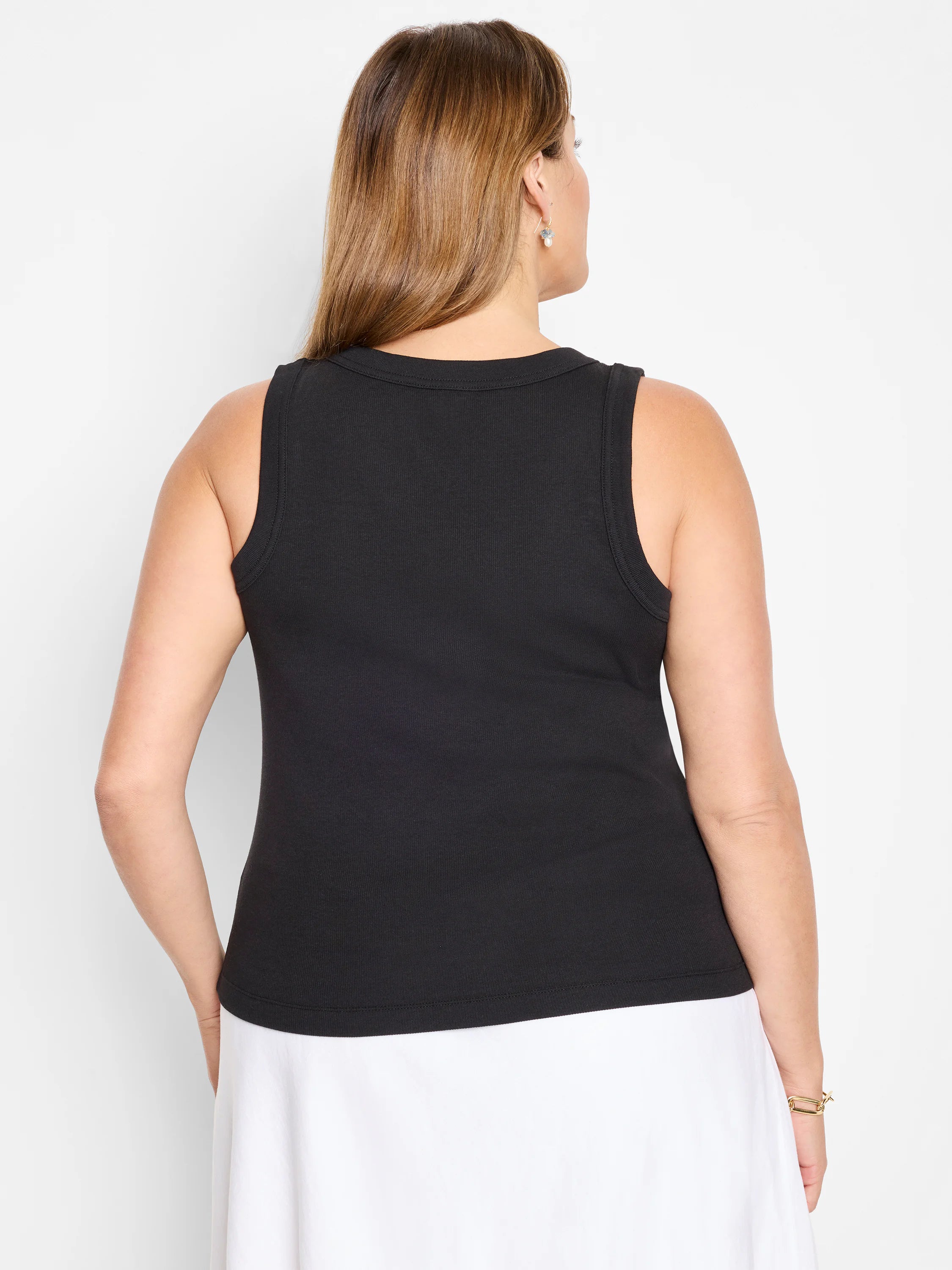 Black ribbed knit scoop tank, shown from the back on a model.