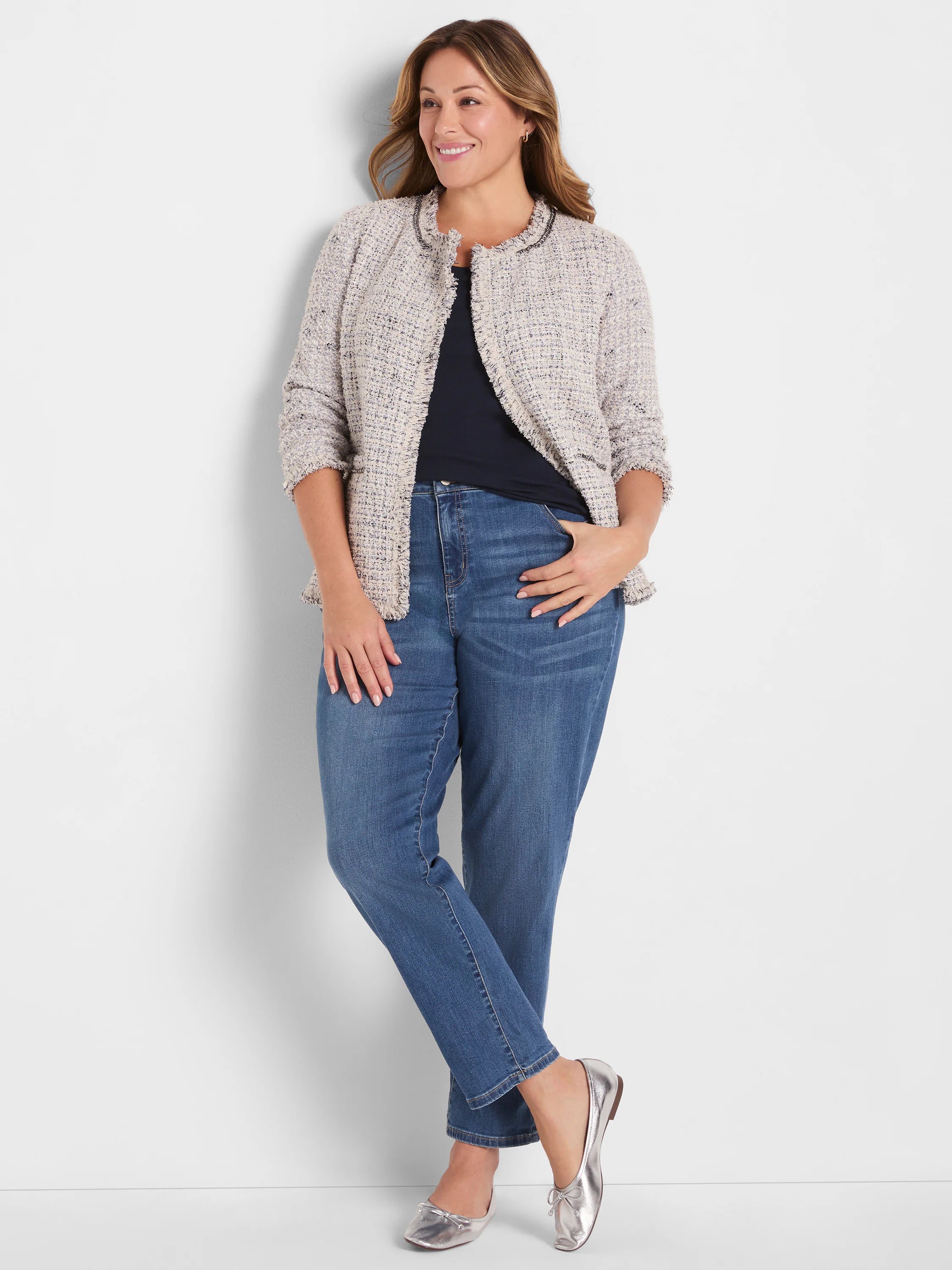 Dark navy ribbed knit scoop tank, partially visible under a light jacket.