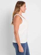 White ribbed knit scoop tank on a woman, shown in profile.