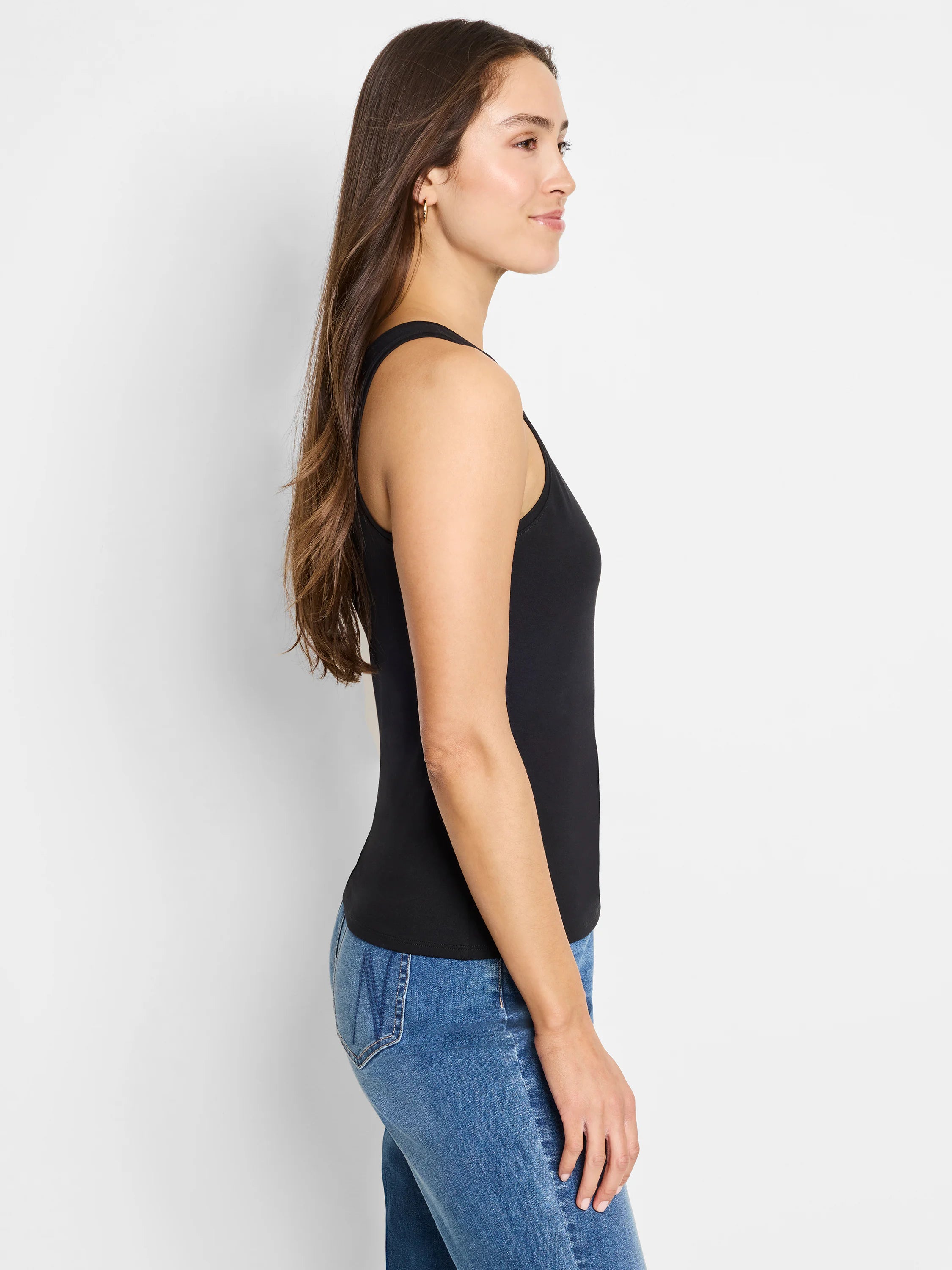 Black fitted high neck tank top. Model from the side.