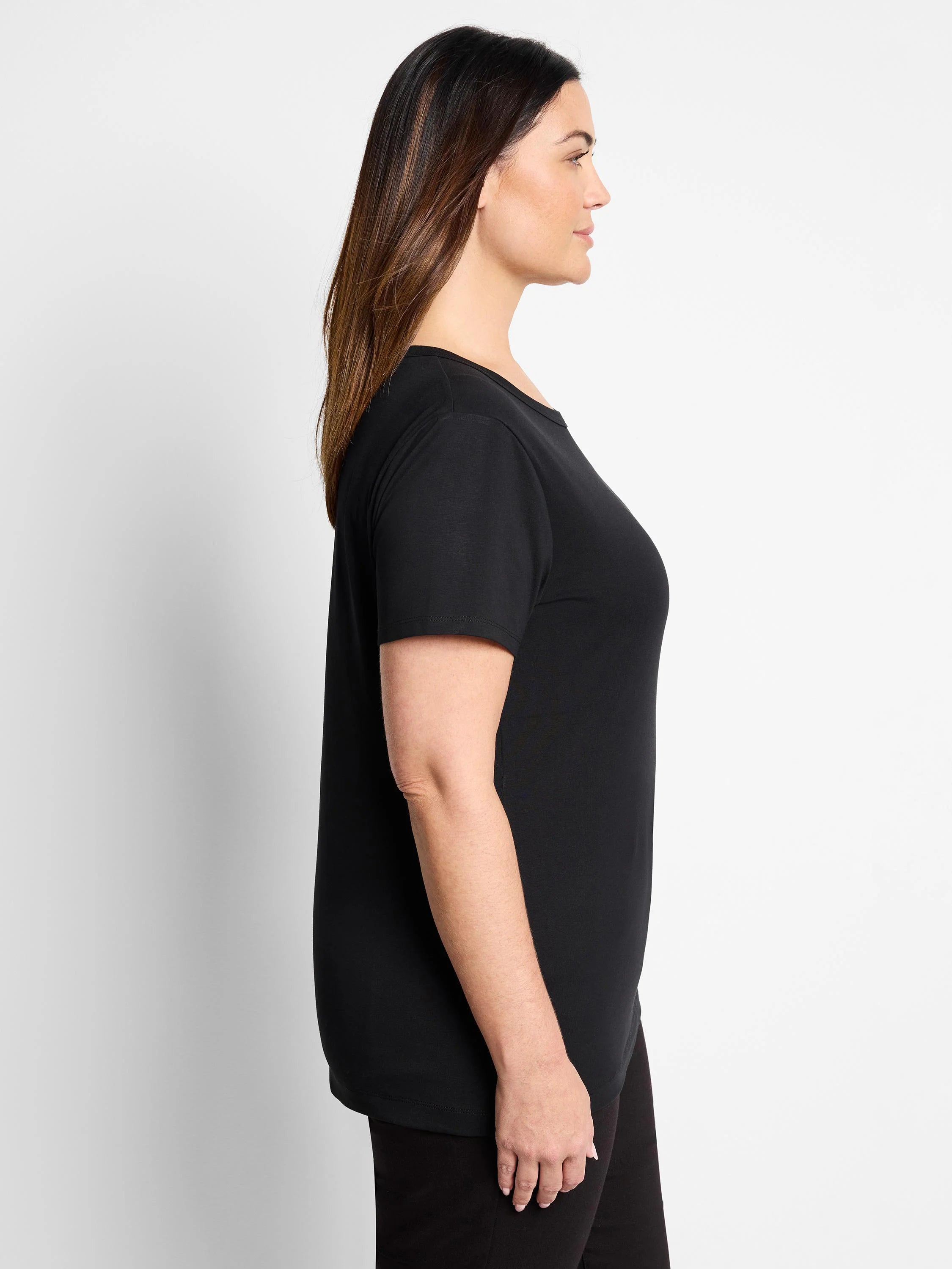 Black short-sleeve crew neck t-shirt with a smooth knit texture, worn by a woman in profile.