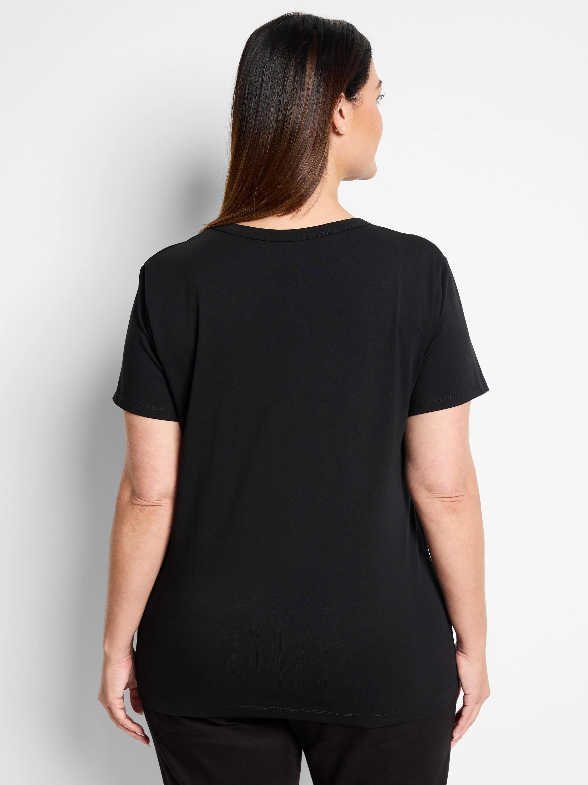 Black crew neck t-shirt, back view on model. Short sleeves, smooth knit fabric.