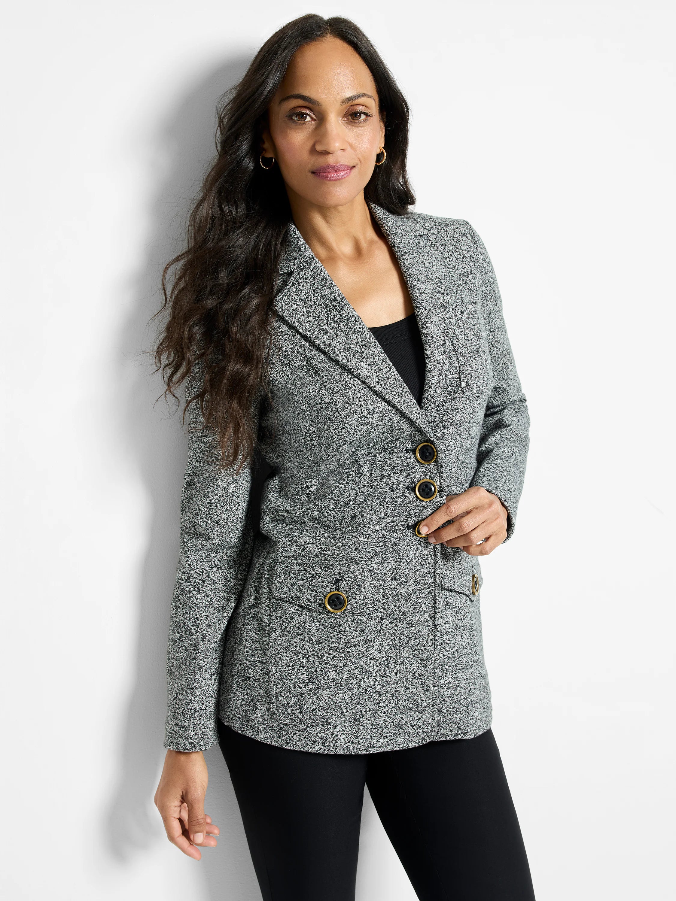 Speckled grey knit blazer with notched lapels, three front buttons, and two patch pockets, all with gold-rimmed buttons.