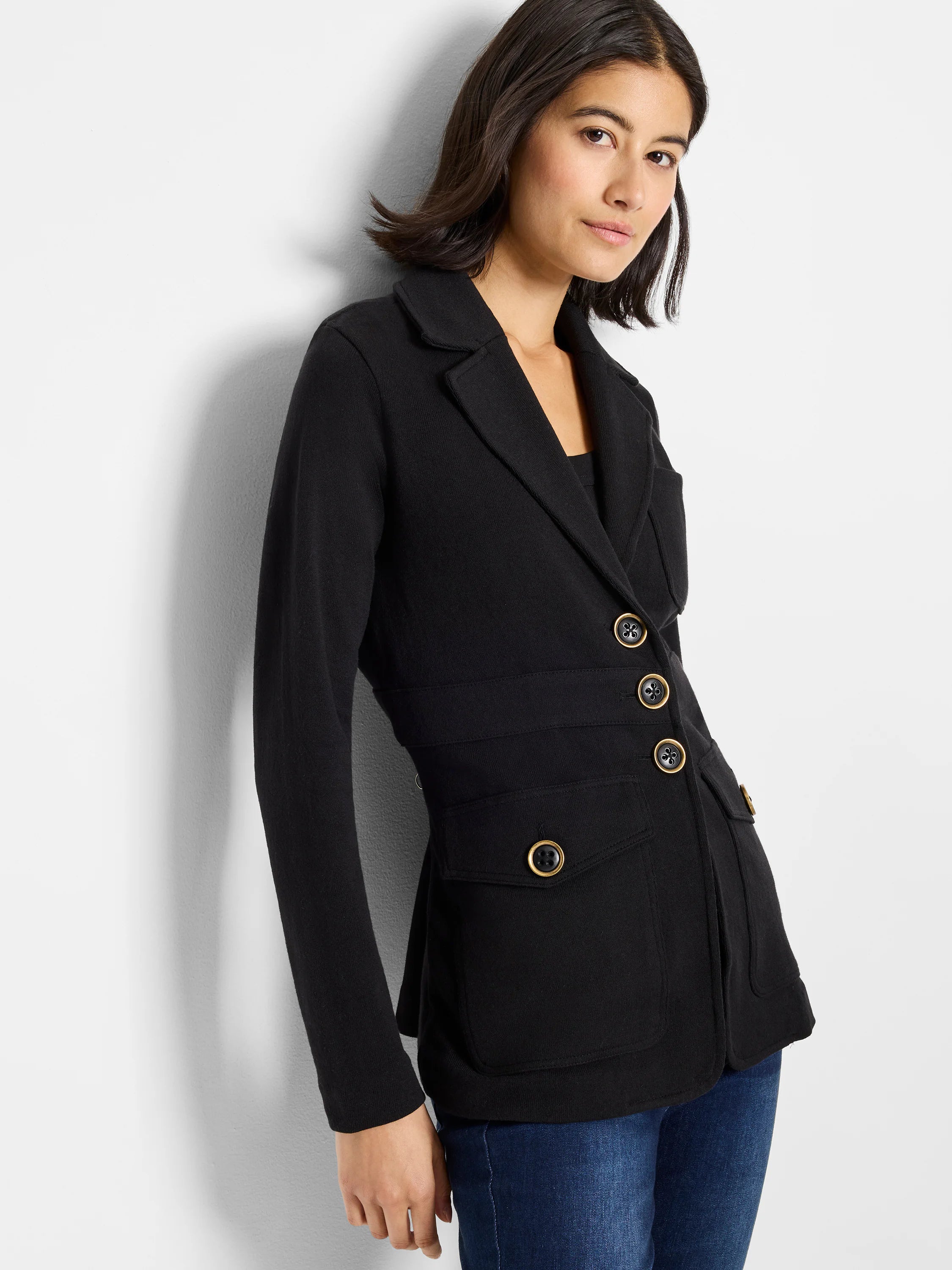 Black knit blazer with lapel collar, long sleeves, gold-toned double-breasted buttons, and two front patch pockets.