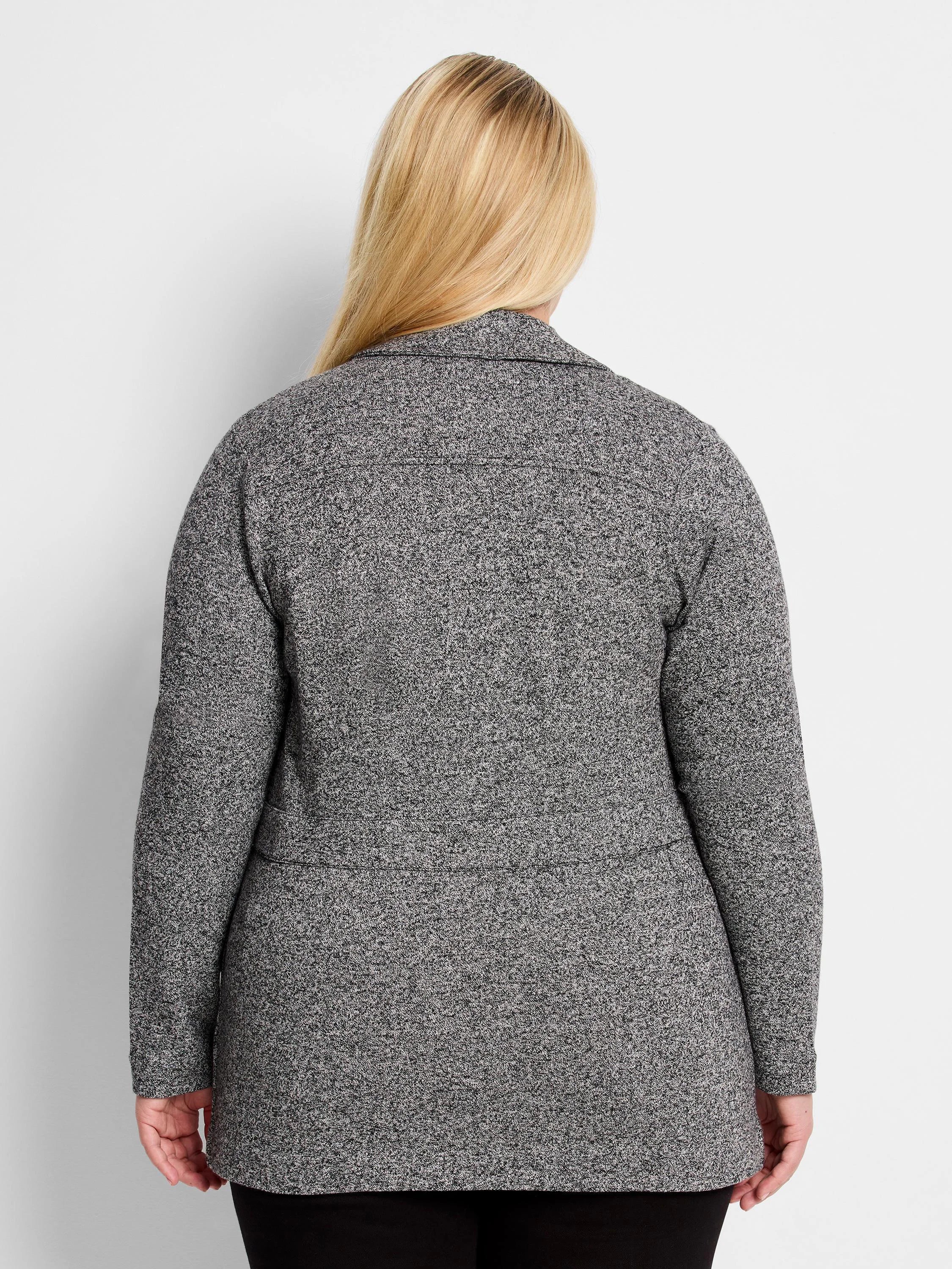 Speckled black and white knit blazer, back view. Features a collar and a horizontal seam detail at the waist.