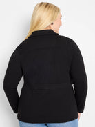 Black knit blazer, back view. Features a collar, long sleeves, top yoke, and a banded detail at the lower back.