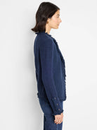 Navy textured knit jacket with fringe along the front opening and cuffs, plus silver buttons on sleeves.