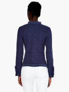 Rear view of a navy mix knit jacket with fringe trim on the collar, hem, and cuffs.