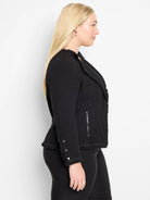Black textured knit jacket with fringe on edges. Features silver zipper and cuff buttons.
