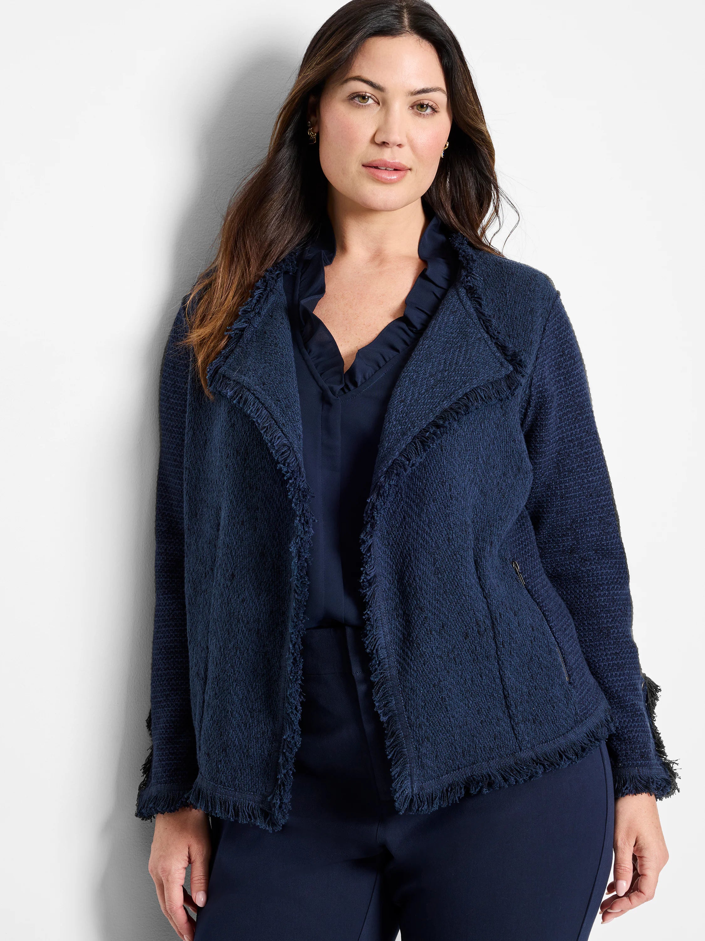 Navy textured knit jacket with fringe on the front edges and cuffs.