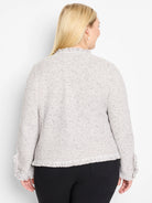 Light gray mixed knit jacket with dark flecks, featuring fringe at the bottom hem and sleeve cuffs.