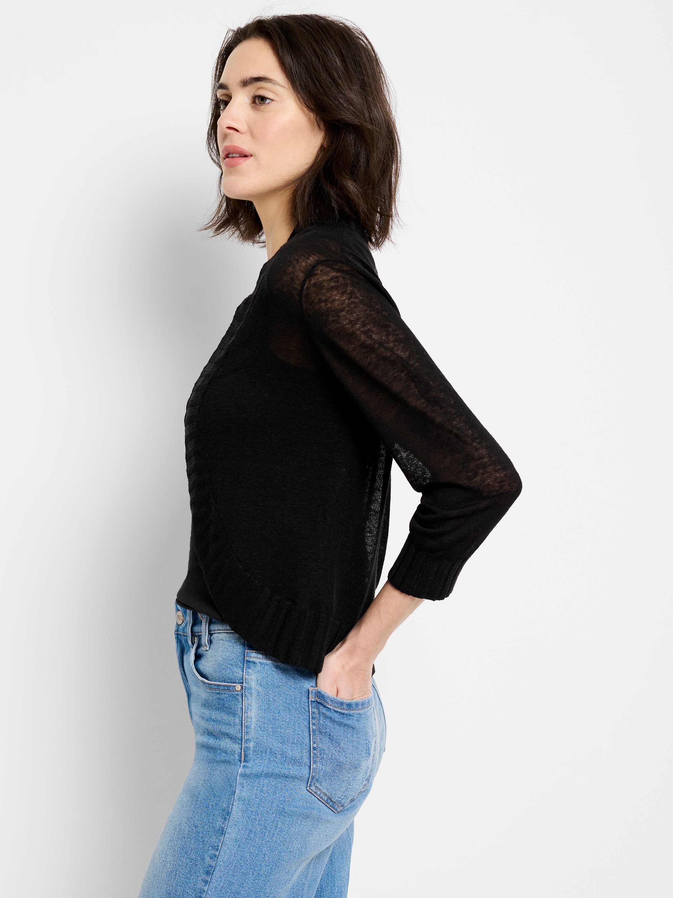Black fitted lightweight knit sweater features textured paneling and sheer three-quarter sleeves.