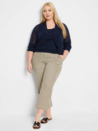 Navy bolero cardigan with sheer knit body, 3/4 sleeves, and ribbed cuffs/front trim. Open front.