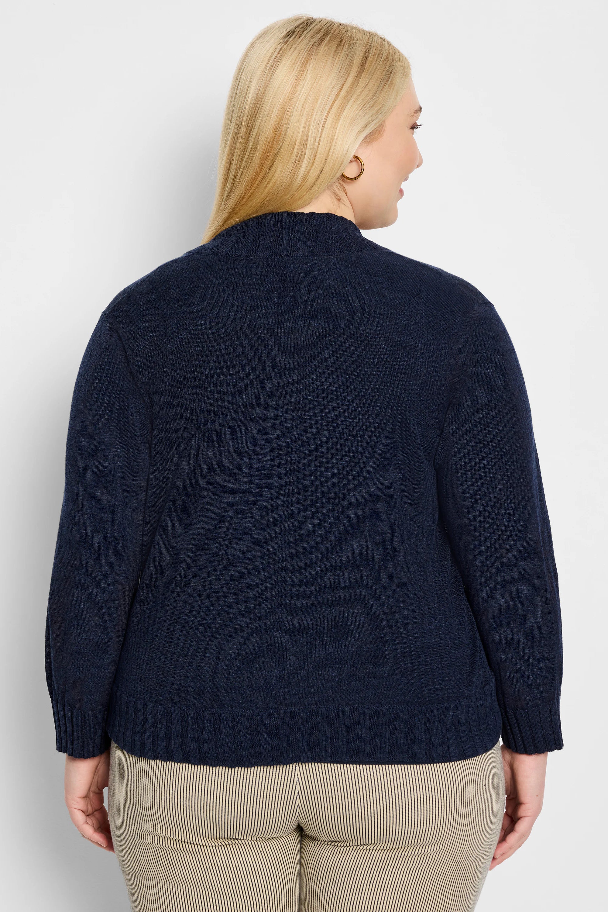 Deep navy blue textured knit bolero cardigan, mock neck, ribbed cuffs and hem, back view on model.