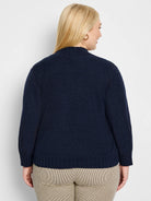 Deep navy blue textured knit bolero cardigan, mock neck, ribbed cuffs and hem, back view on model.