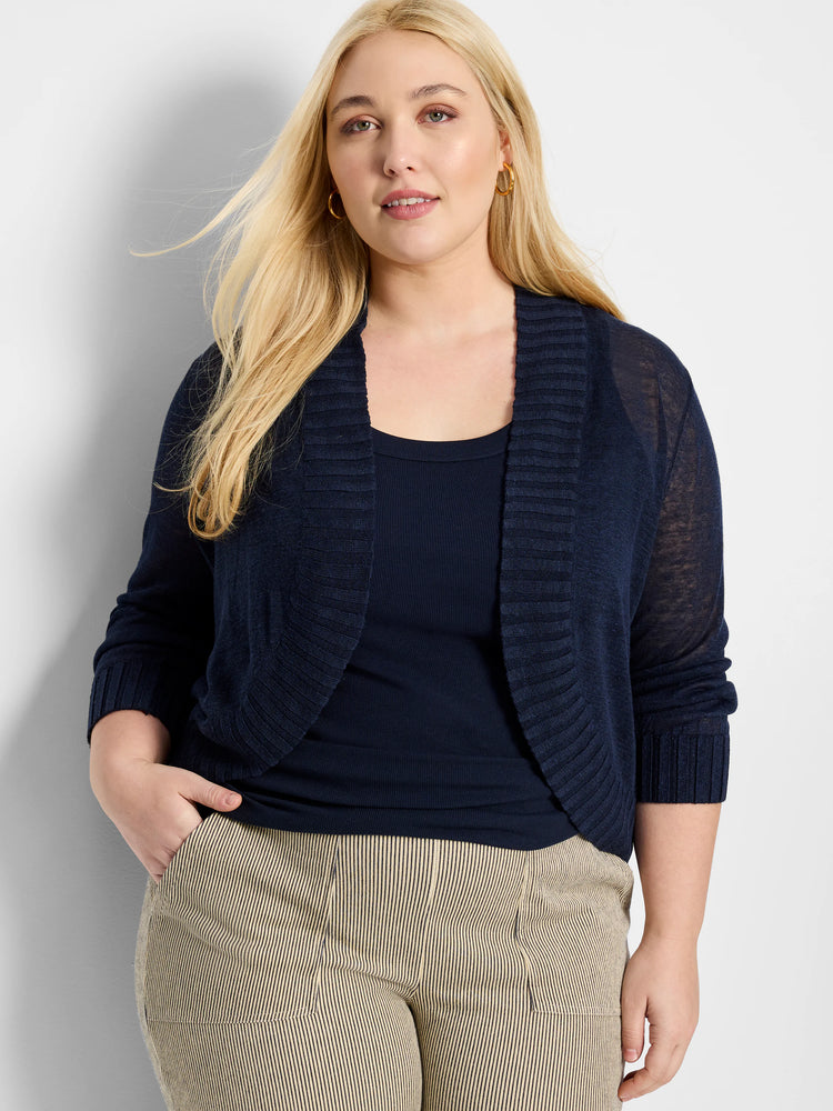 Navy blue bolero cardigan, cropped, open-front with ribbed collar & cuffs, and three-quarter sheer sleeves.