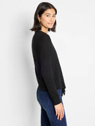 Black long-sleeve cardigan with a fine knit texture and draped, open front.