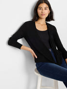 Black open-front cardigan featuring a draped, waterfall design and long sleeves.