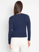 Navy blue long-sleeved knit cardigan with ribbed cuffs and hem, shown from the back.