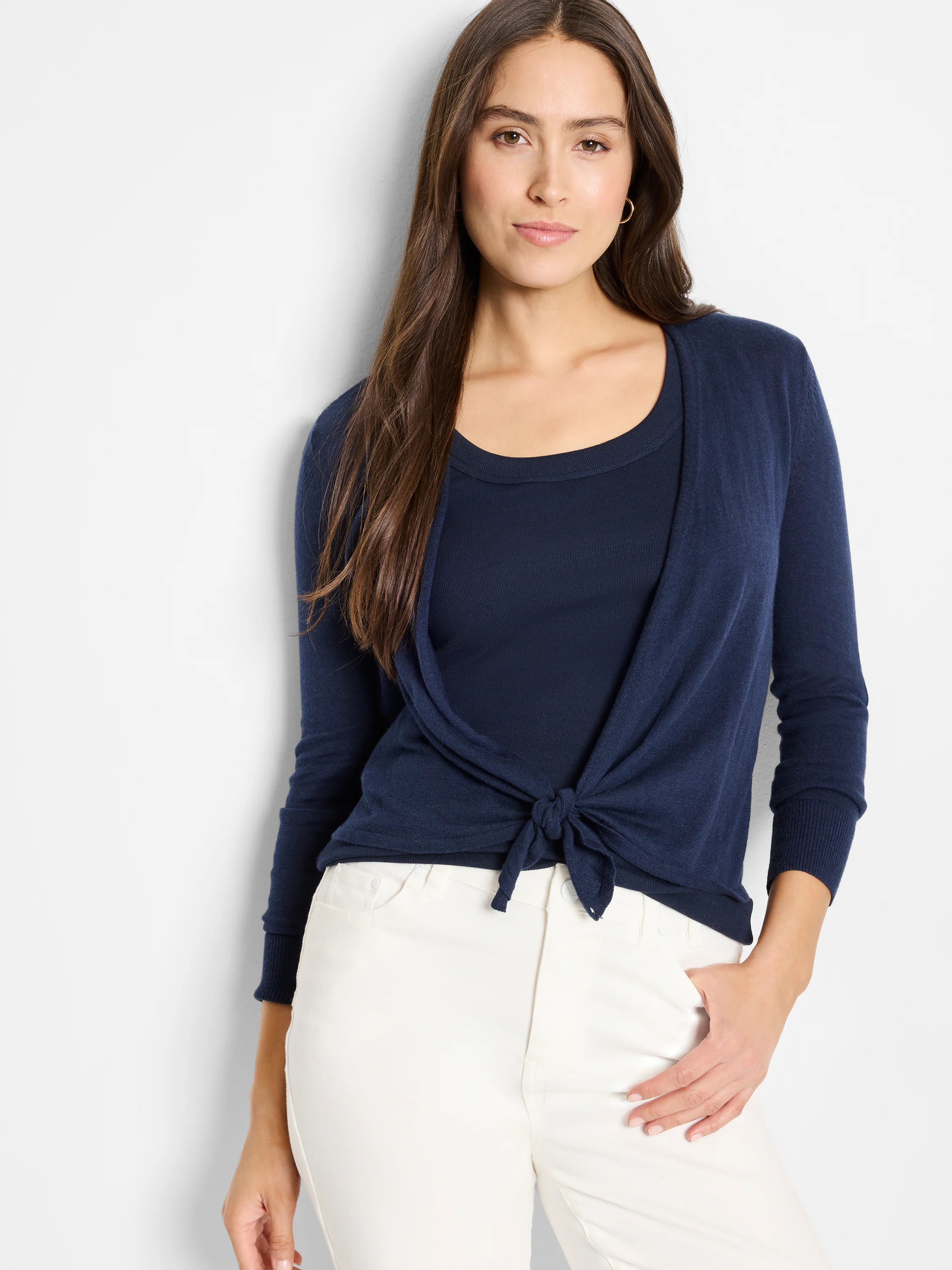 Navy blue fine knit cardigan, tied at front creating a V-neck, with long sleeves and ribbed cuffs.