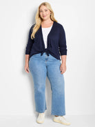 Dark navy blue cardigan, tied at the waist. Features long sleeves with ribbed cuffs.