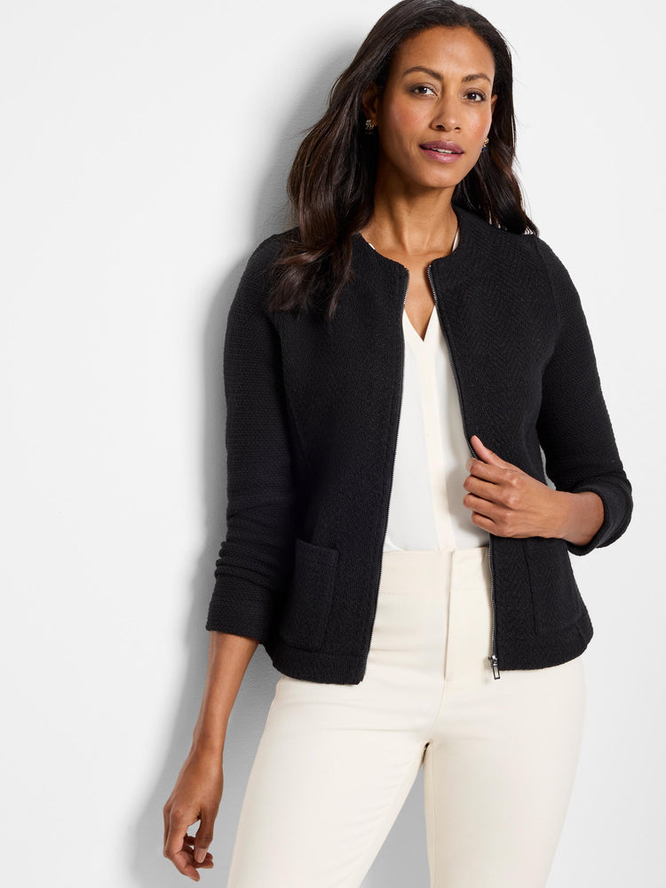 Black textured knit collarless jacket with a slim fit, exposed silver zipper, and cropped length.
