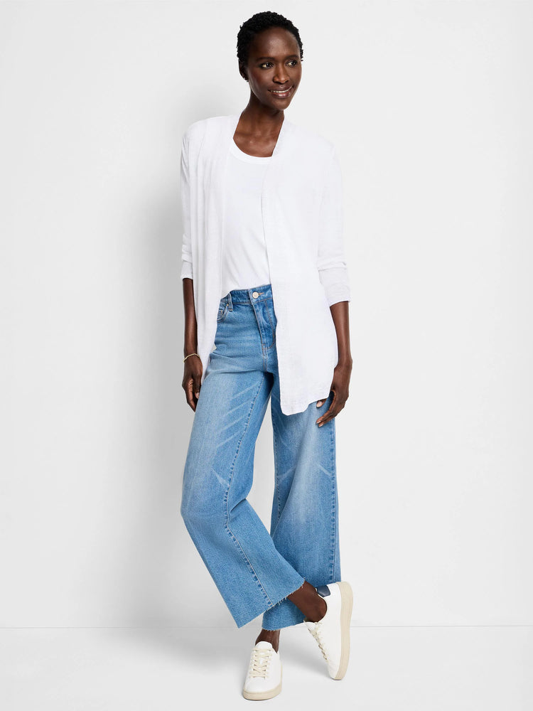 White open-front cardigan, long sleeves. Model wears it over a white top and light blue jeans.
