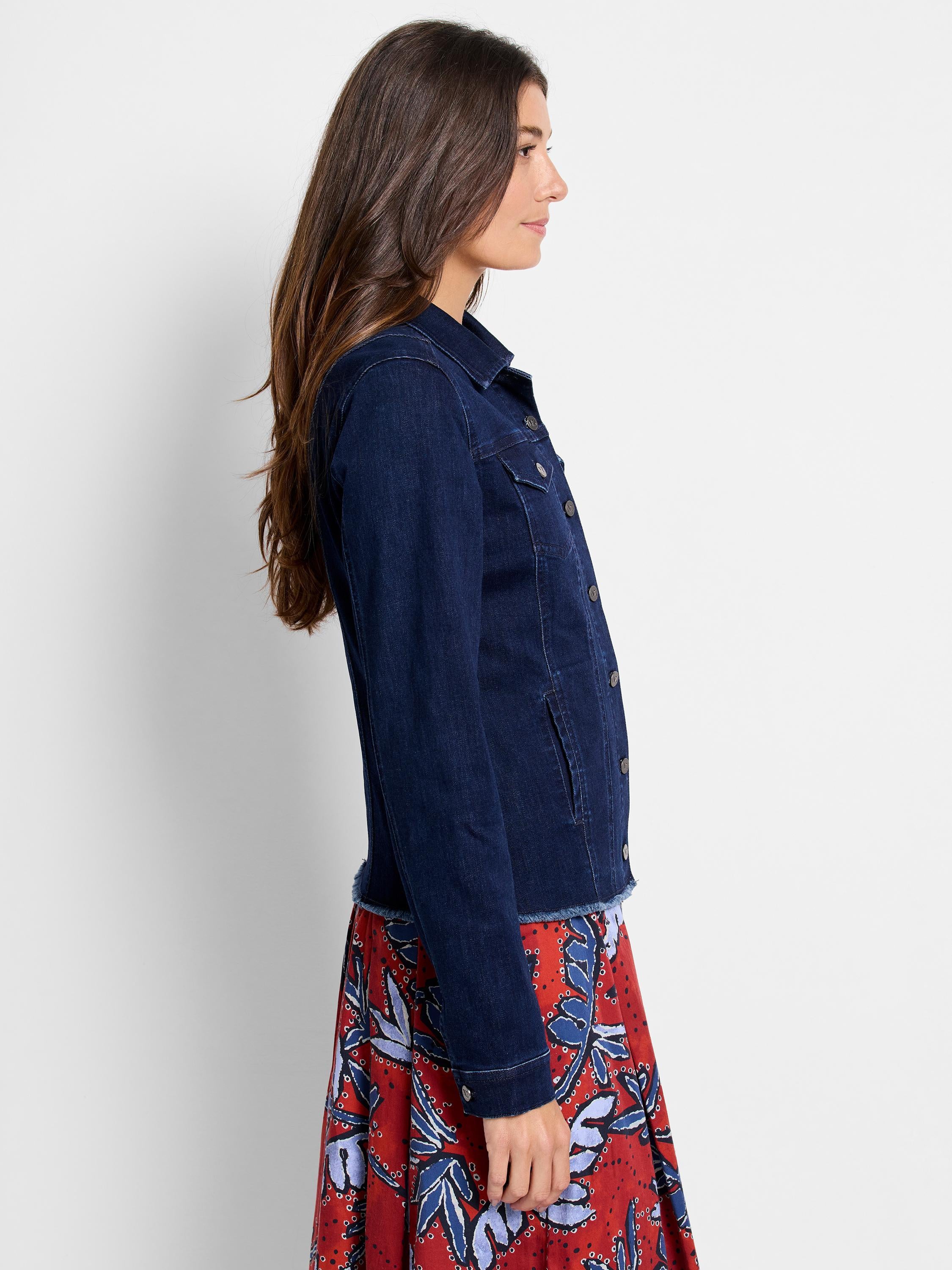 A fitted dark wash denim jacket features classic chest pockets and a stylish frayed raw hem.