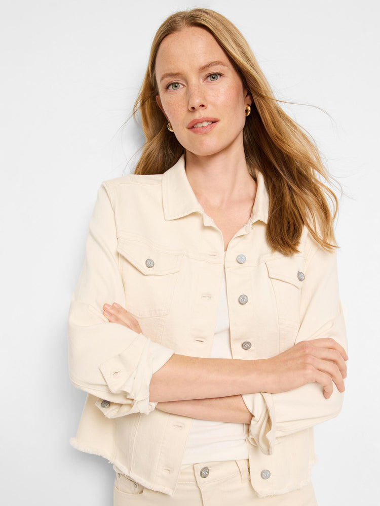 Cropped denim jacket in cream or off-white with a fitted silhouette. Features include a classic collar, button front closure with branded silver buttons, chest flap pockets, and raw, frayed edges along the hem and cuffs. The jacket is paired with mat