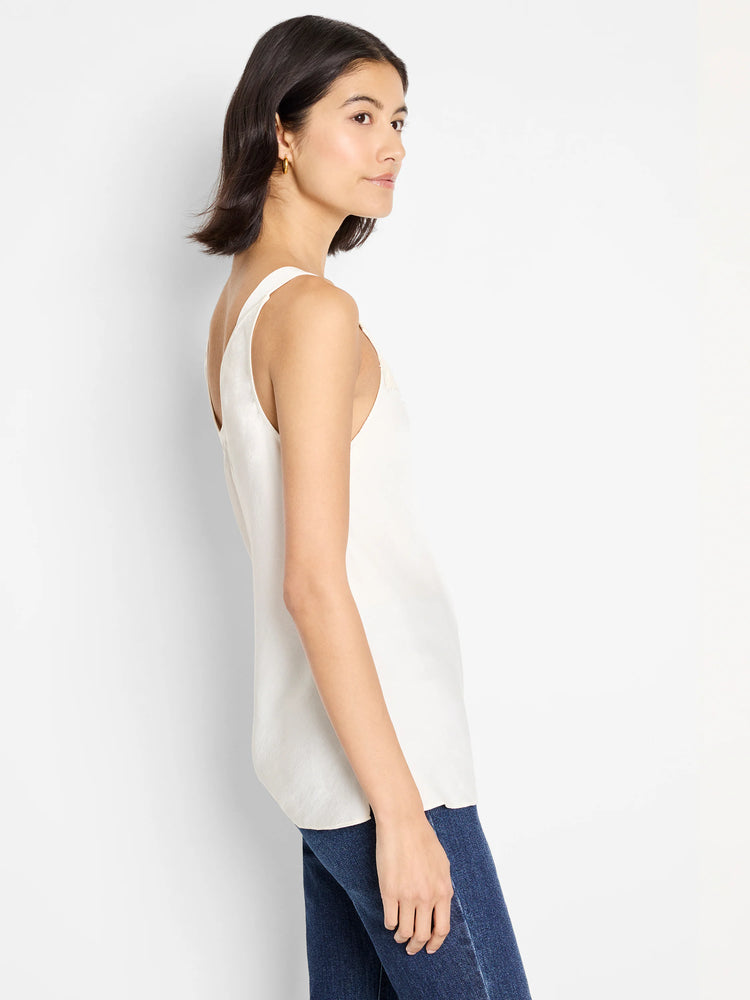 Ivory cami tank with wide straps on model. Smooth fabric, slight sheen.