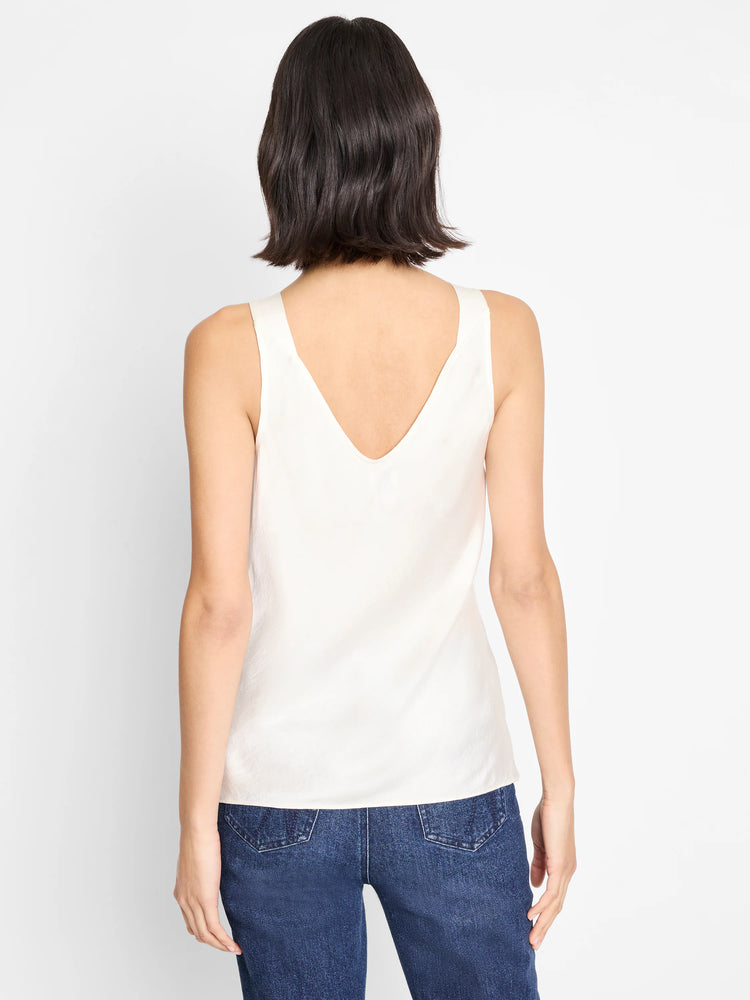 Cream cami tank with sleeveless design and V-neck back.