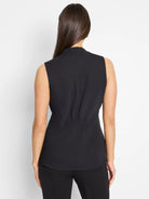 Black sleeveless top, back view. Features a stand collar and horizontal shirring at the back waist.