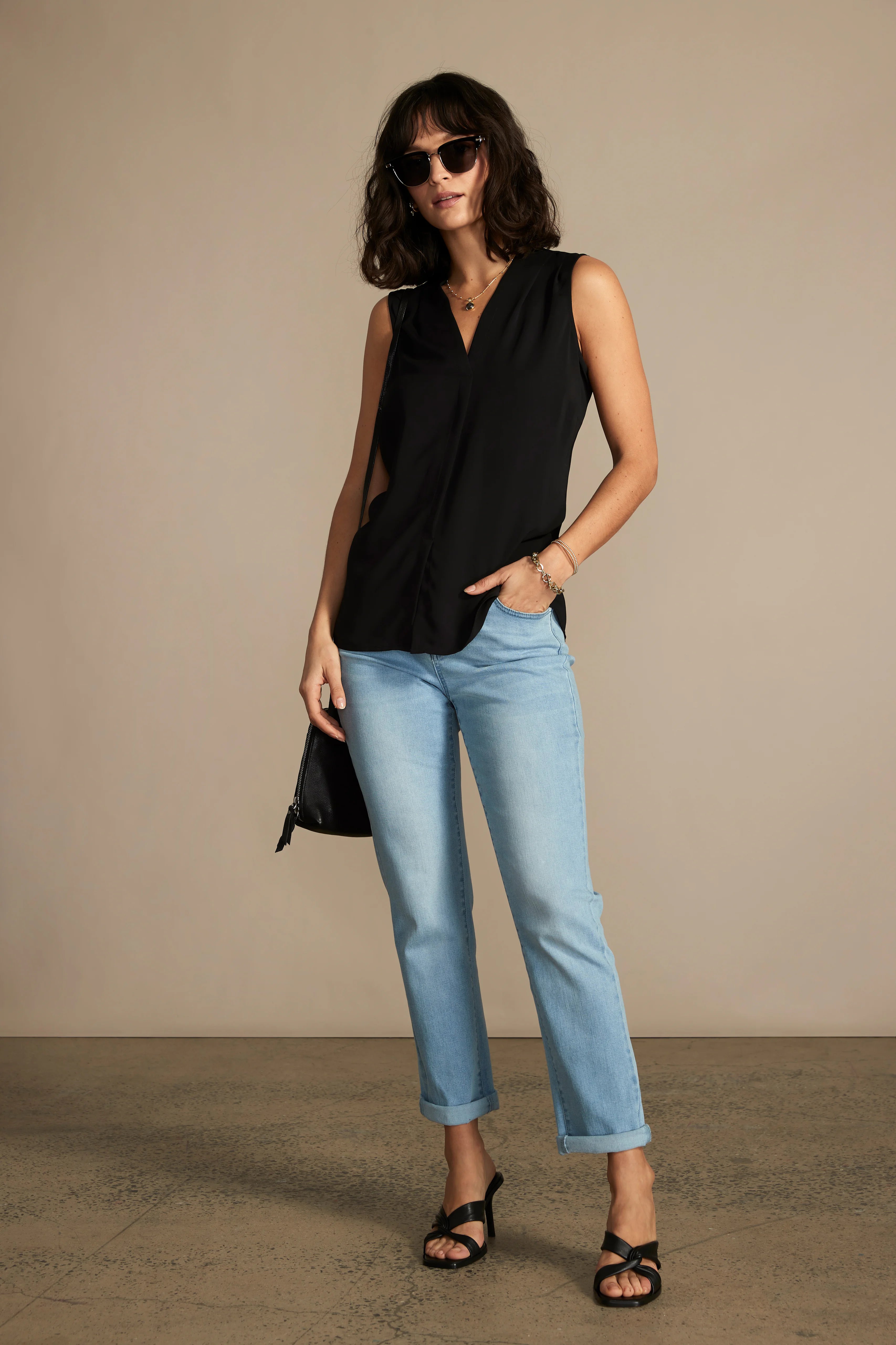 Black sleeveless V-neck top shown on model.