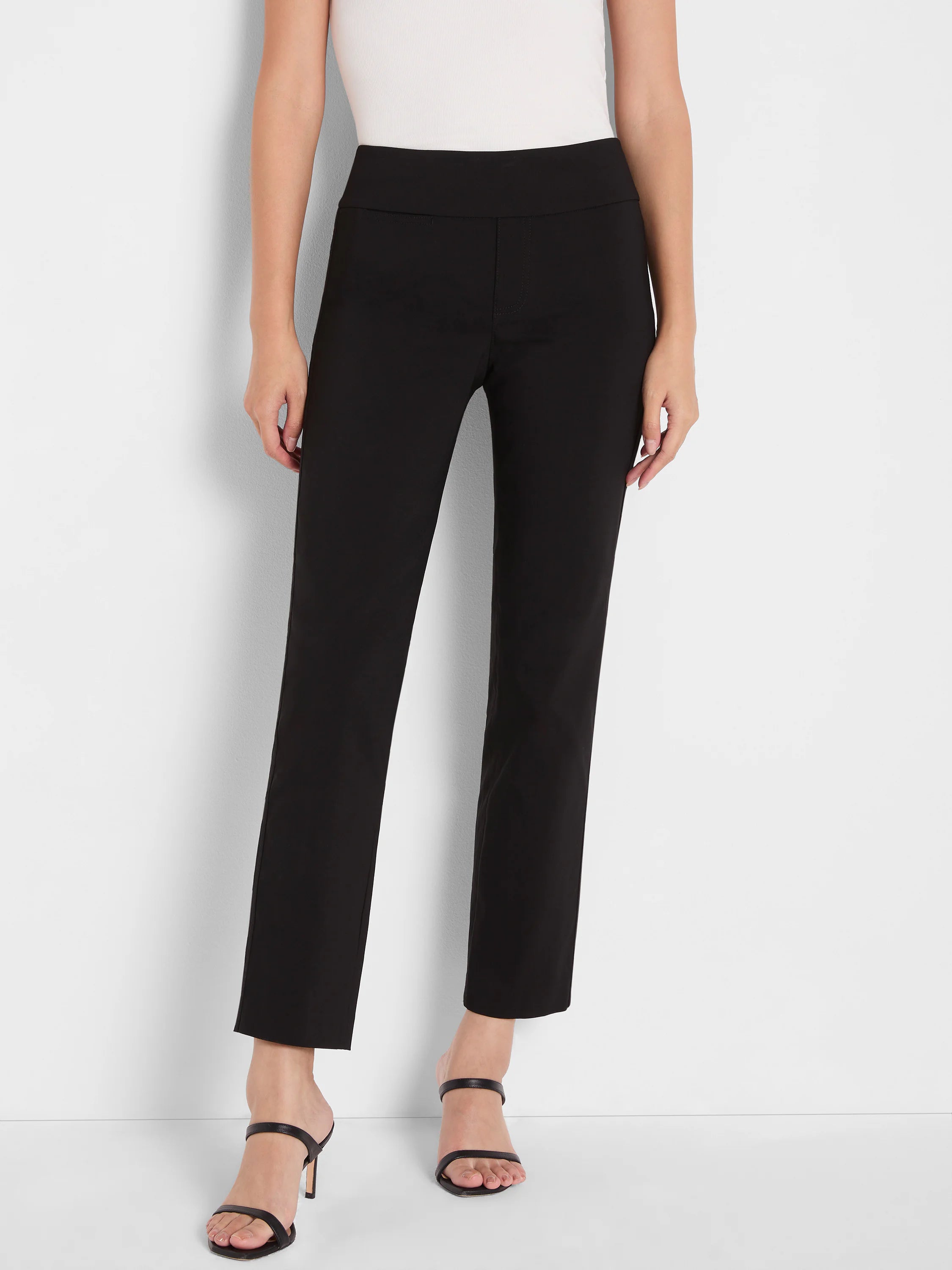 Black high-waisted ankle pants with a wide waistband, styled on a model.
