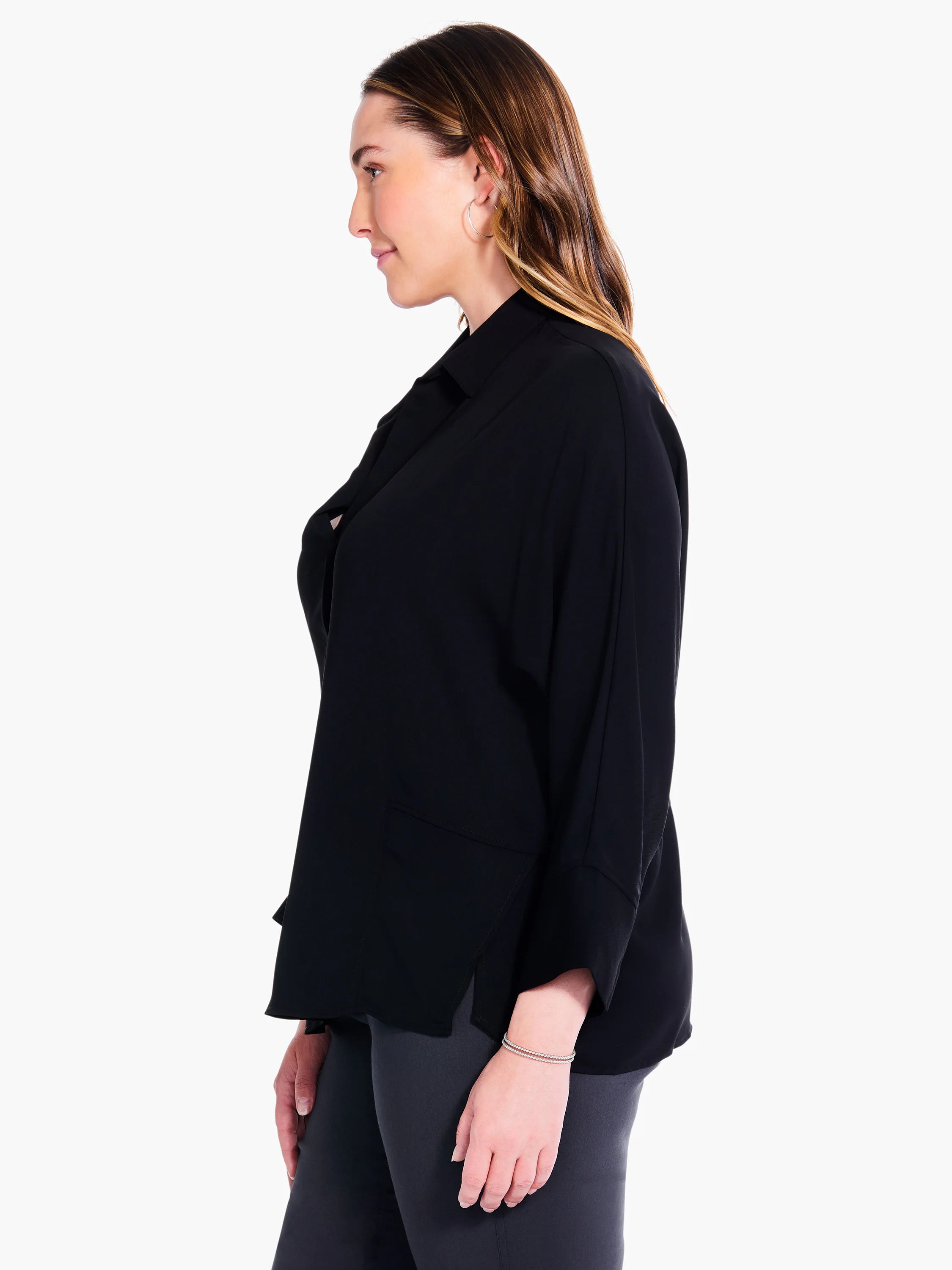 Black collared blouse, three-quarter sleeves, side slits. Model shown in profile.