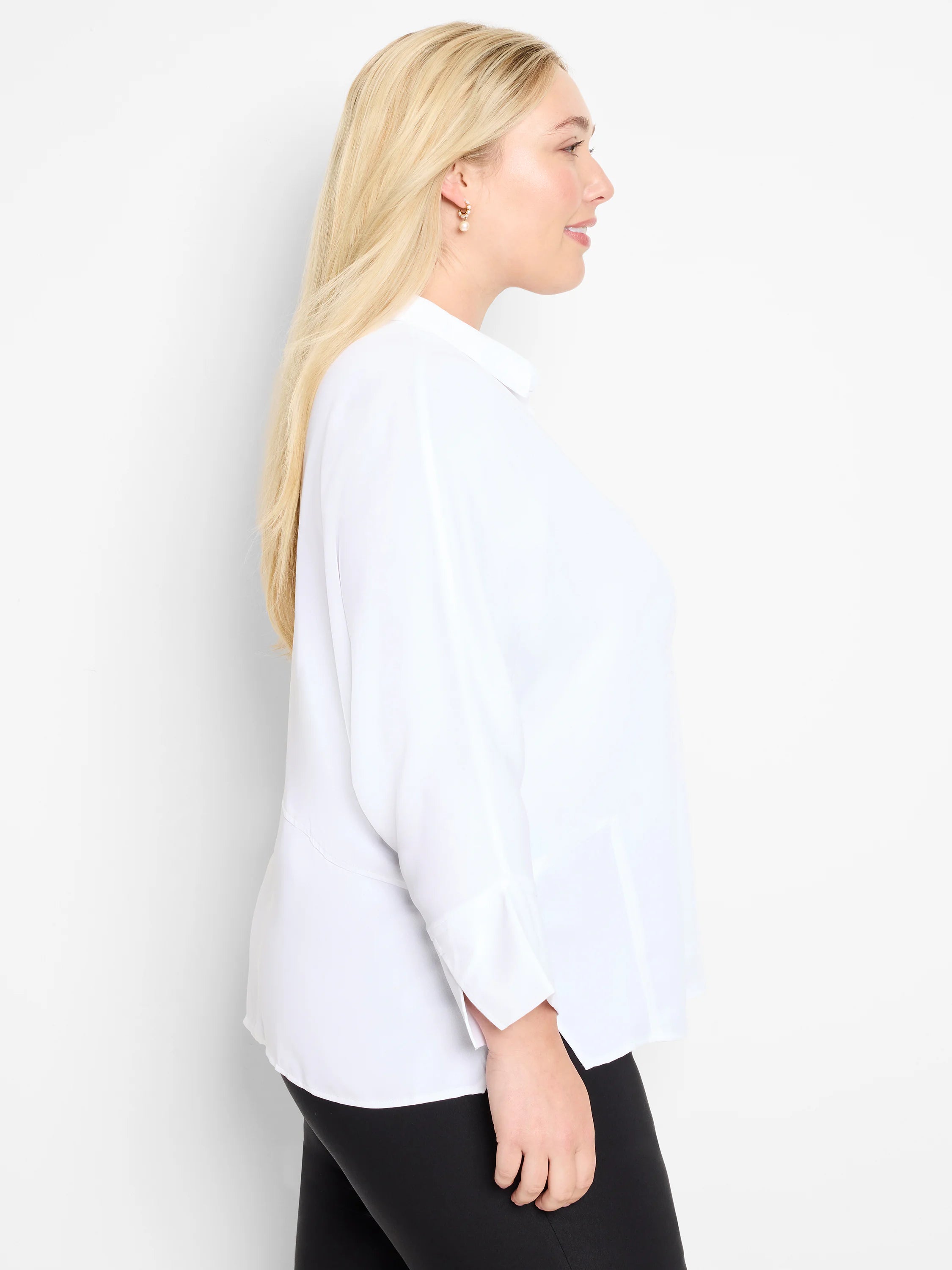 White collared blouse, three-quarter sleeves, slightly loose fit. Shown on model.