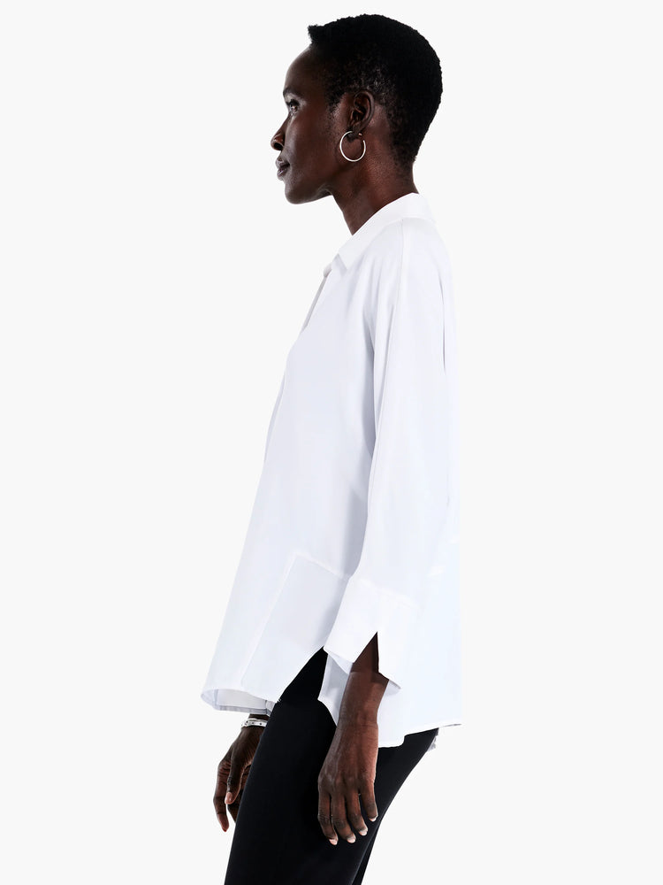 White collared, long-sleeve blouse; loose fit, slightly longer in back.
