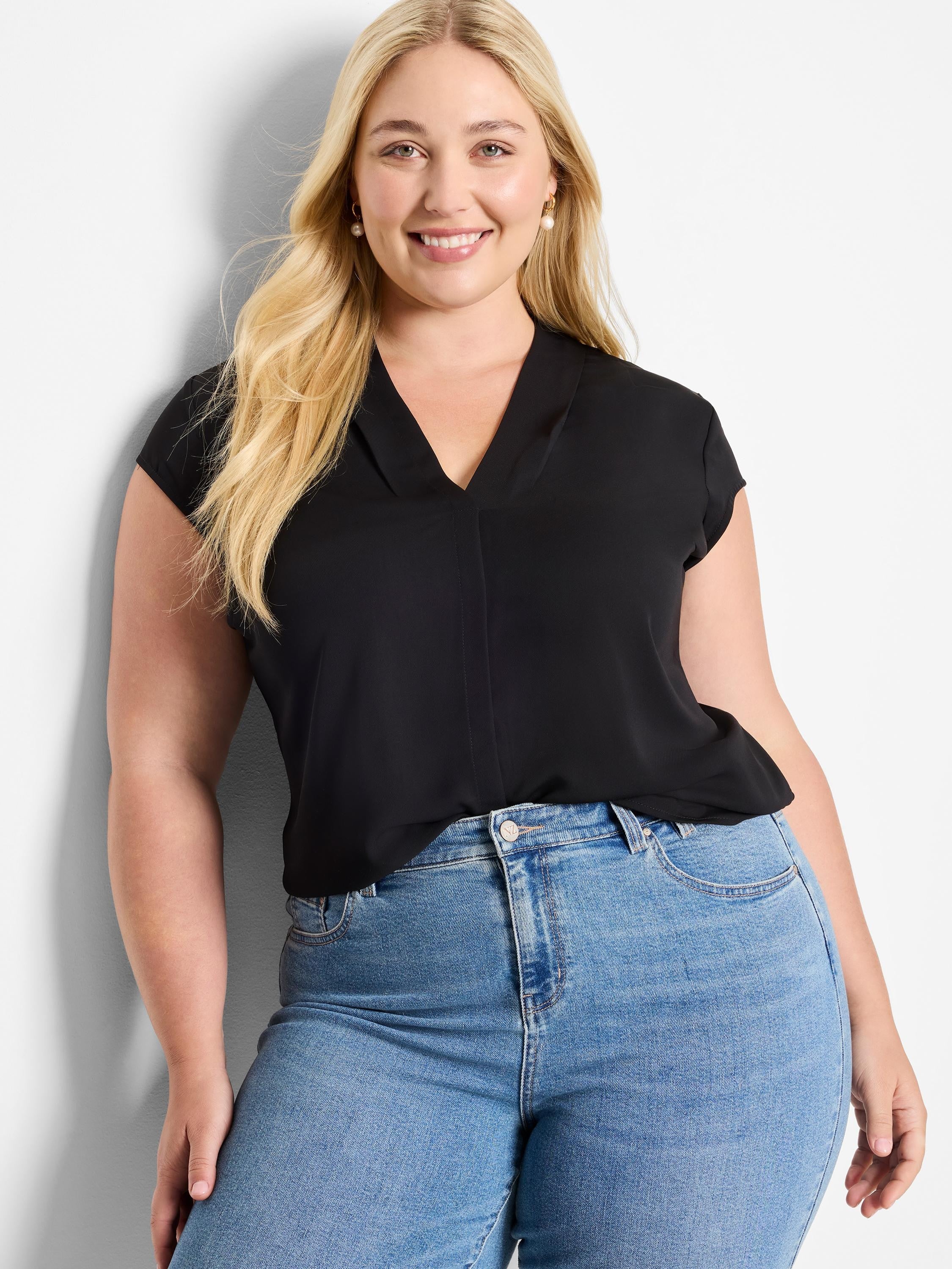Black cap sleeve top with a relaxed V-neck and a subtle center front seam, modeled.