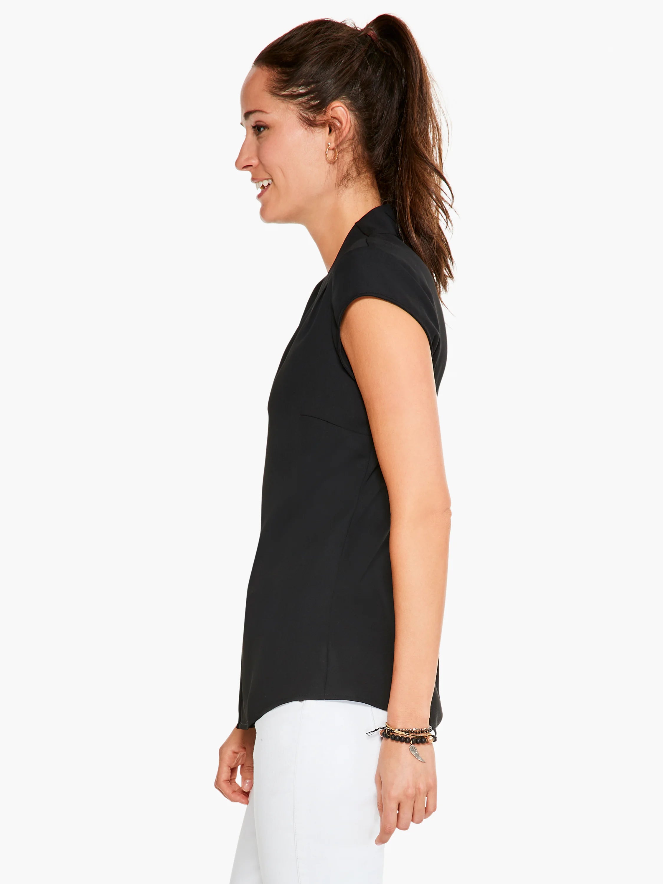Black cap-sleeve top, shown in profile.  A-line silhouette.