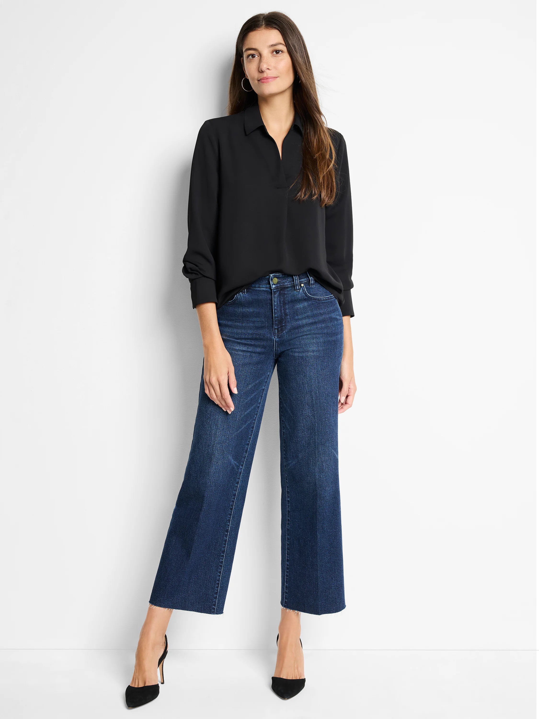 Black popover shirt with a collar, V-neck, and long cuffed sleeves.