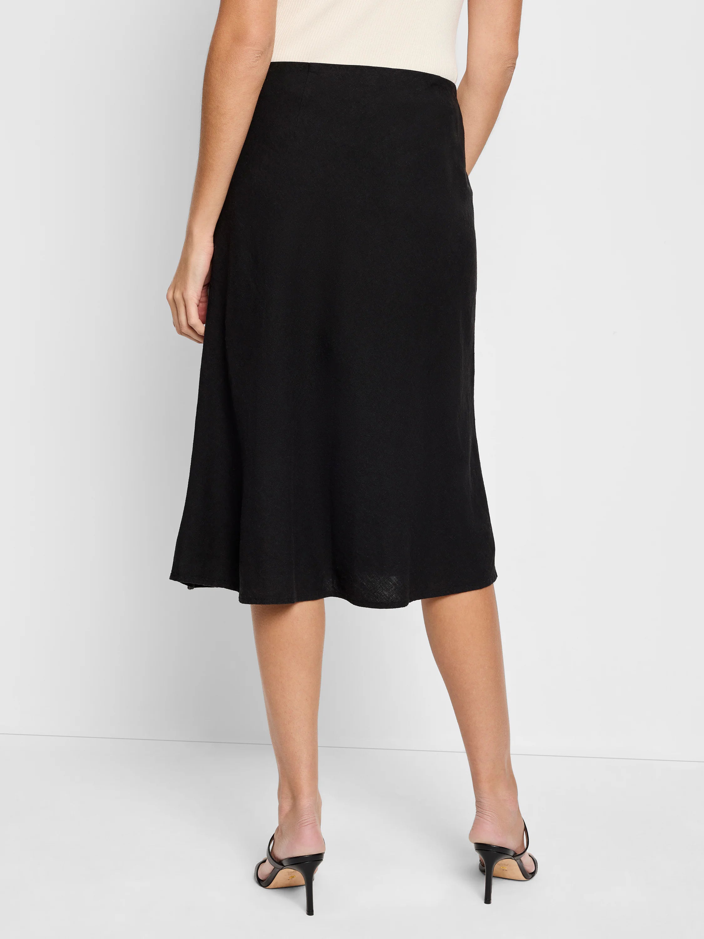 Black linen midi slip skirt; A-line silhouette.