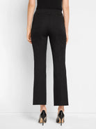 Black demi-boot pants, rear view. Features back patch pockets with topstitching and belt loops. Cropped length.