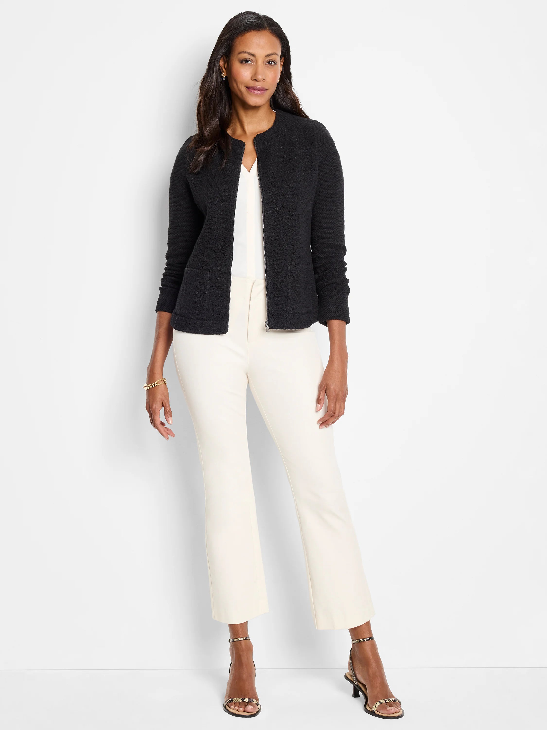 Light cream cropped demi boot-cut pants, slightly flared at the ankle.