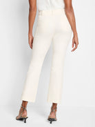 Cream demi-boot pants with belt loops, two back patch pockets, and a cropped leg.